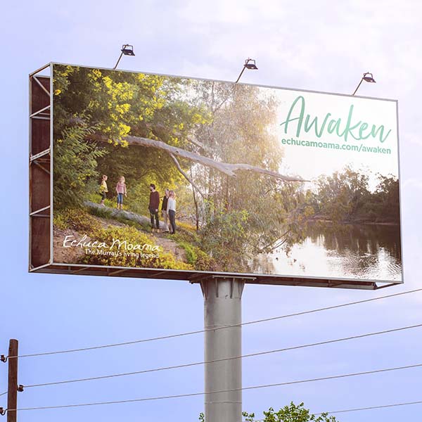 Landscape billboard image with four people walking through the creek near water and trees.